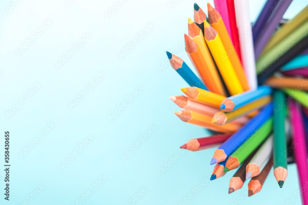 Palette kit of multi colored pencils on green background. Space for text, back to school. Sketching and drawing hobby. Stationery supply store Palette kit of multi colored pencils on green background. Space for text, back to school. Sketching and drawing hobby. Stationery supply store