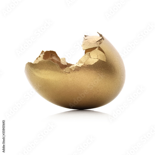 Konstfotografi Gold cracked egg isolated on a white background.