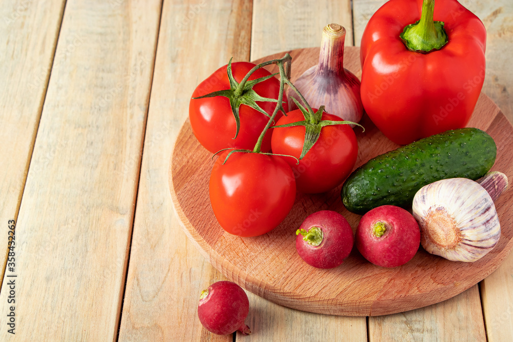 Set of fresh vegetables in a basket on a wooden background. The concept of healthy nutrition and diet. Set of fresh vegetables in a basket on a wooden background. The concept of healthy nutrition and diet.