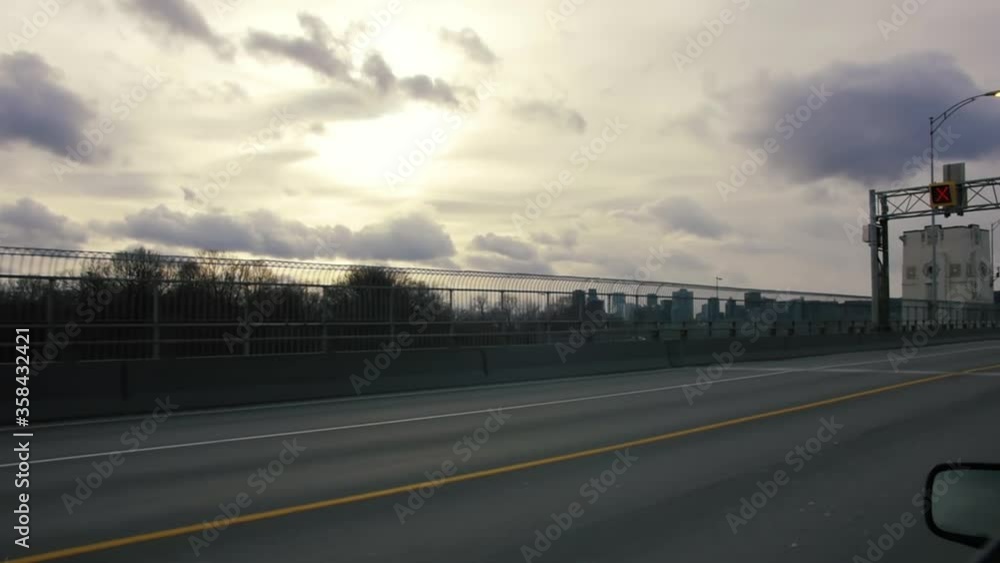 MONTREAL, CANADA - March 17 2019 Tracking traveling shot of vehicle driving over Jacques Cartier Bridge, aged old structures stand on the bridge side. MONTREAL, CANADA - March 17 2019 Tracking traveling shot of vehicle driving over Jacques Cartier Bridge, aged old structures stand on the bridge side.