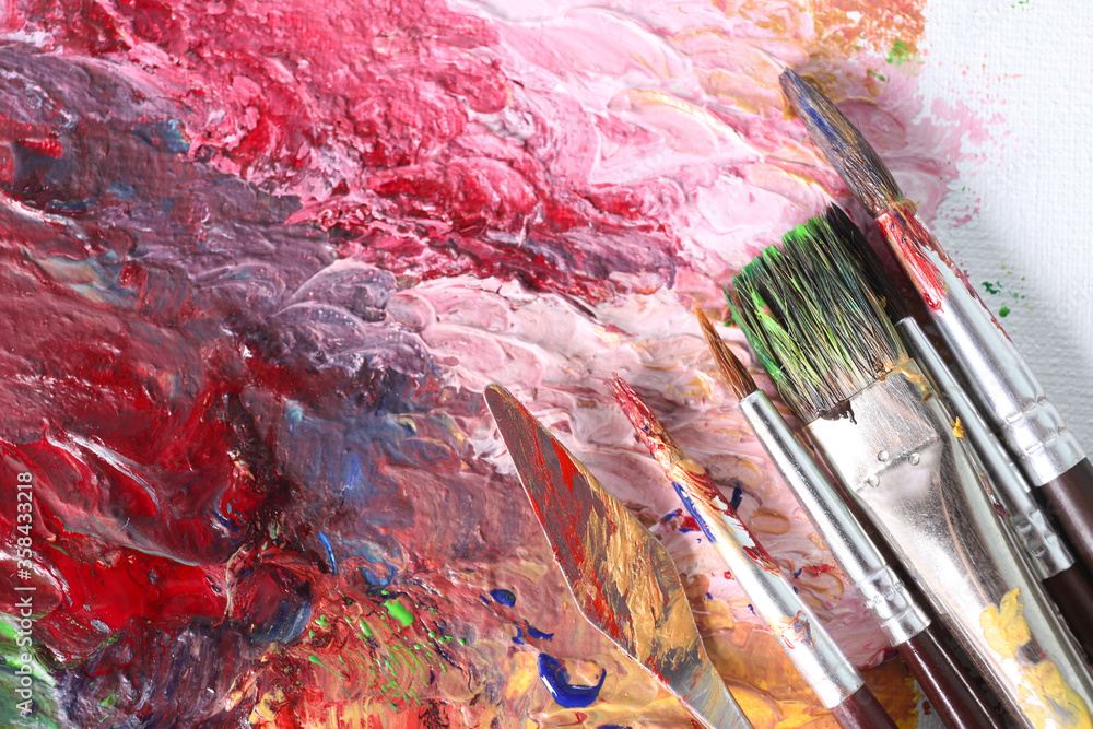 Fototapeta premium Abstract colorful artwork and brushes, closeup view