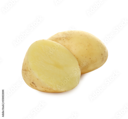 Whole and cut fresh raw organic potatoes on white background