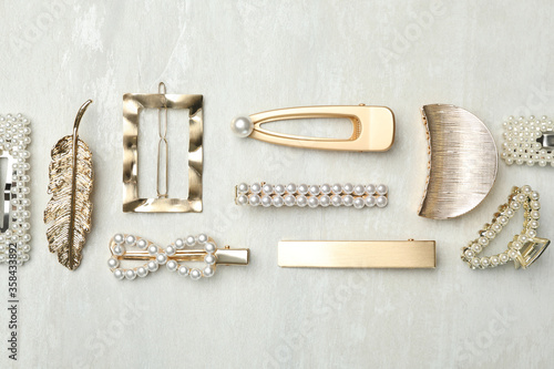 Beautiful different hair clips on white table, flat lay