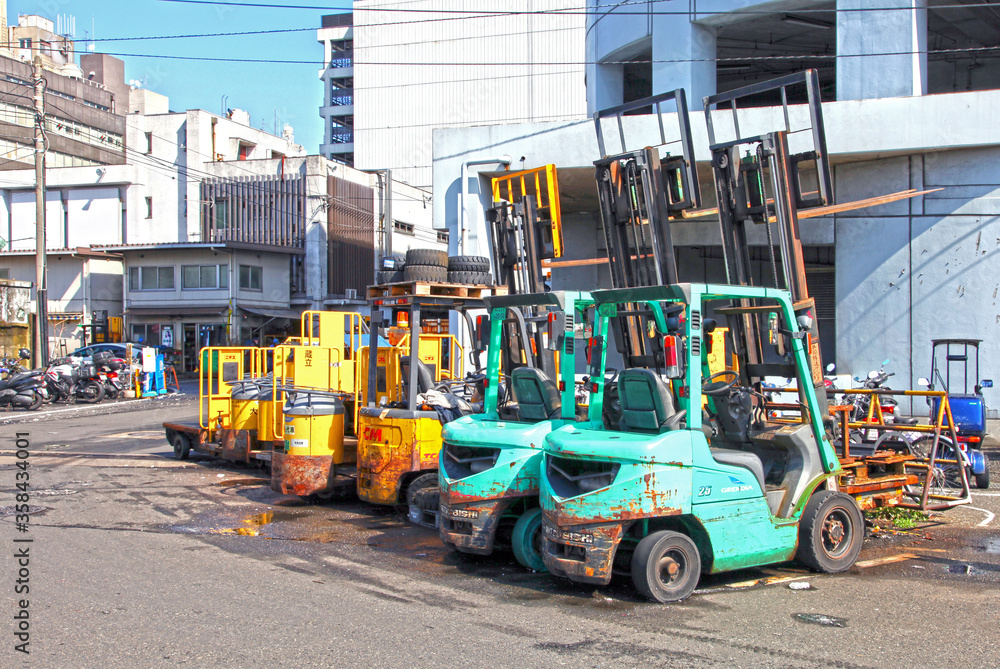 Forklift trucks lined up outside a fish market in Tokyo, Japan. Forklift trucks lined up outside a fish market in Tokyo, Japan.
