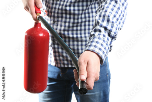 Man using fire extinguisher on white background, closeup photo