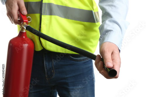 Worker using fire extinguisher on white background, closeup photo