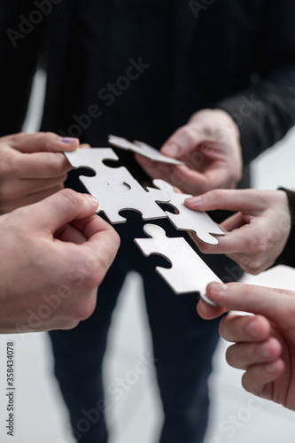 Closeup hand connecting jigsaw puzzle with, business solutions,