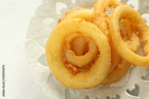 Fast food, onion rings on dish for unhealthy food