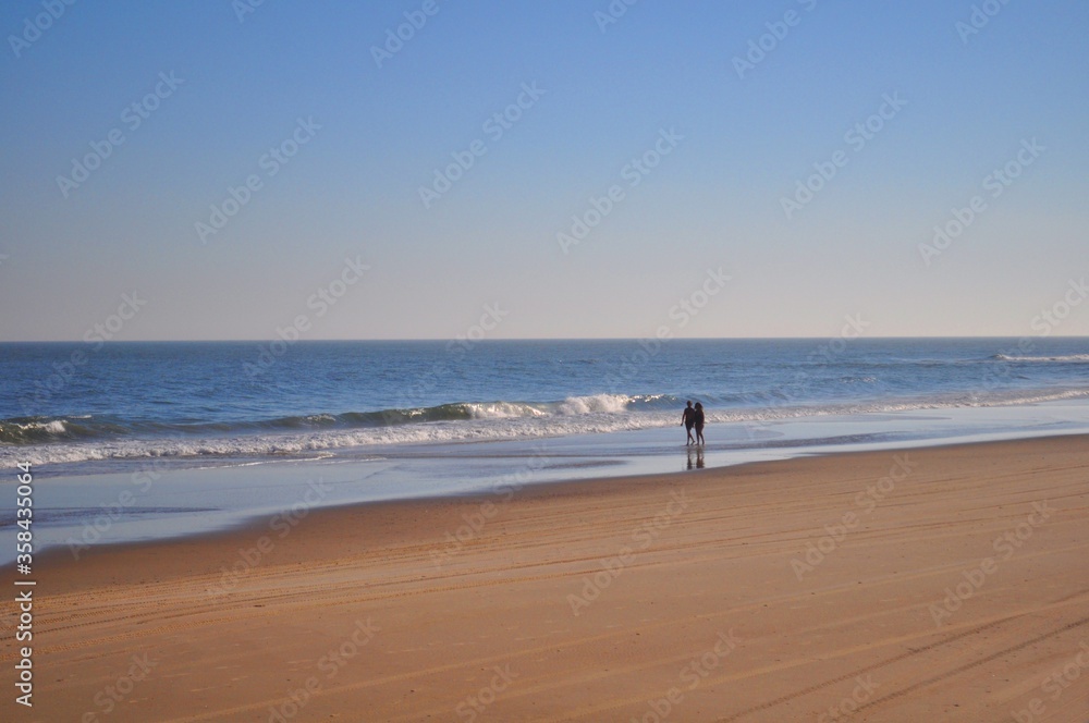 A couple walks on the beach of Cabo Polonio, Rocha, Uruguay