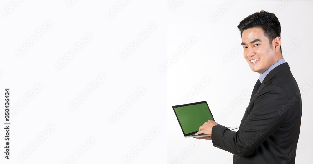 Young businessman use laptops for work and the smiling face is bright. Young businessman use laptops for work and the smiling face is bright.