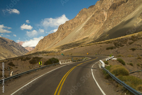 Travel. Rural highway. The asphalt road curve along the mountains and desert. 