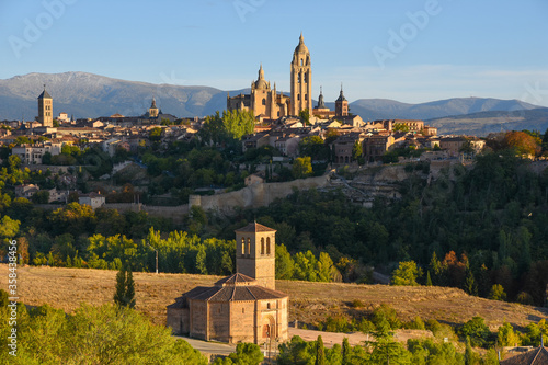 View of the Vera Cruz Church, a unique church in Segovia built by the Knights Templar to house a fragment of the True Cros  with Segovia Cathedral in the background, Spain photo
