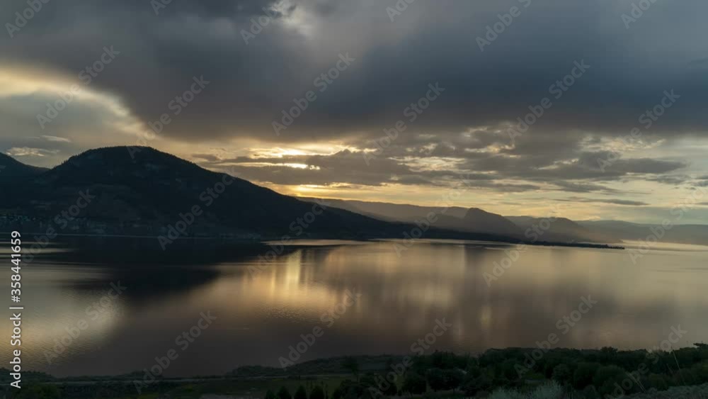 Calm golden sunset time lapse over Okanagan Lake from Munson Mountain. Calm golden sunset time lapse over Okanagan Lake from Munson Mountain.