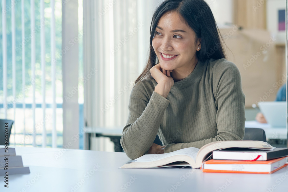 Students read books in the classroom. Asian student in uniform reading book in classroom at university Students read books in the classroom. Asian student in uniform reading book in classroom at university