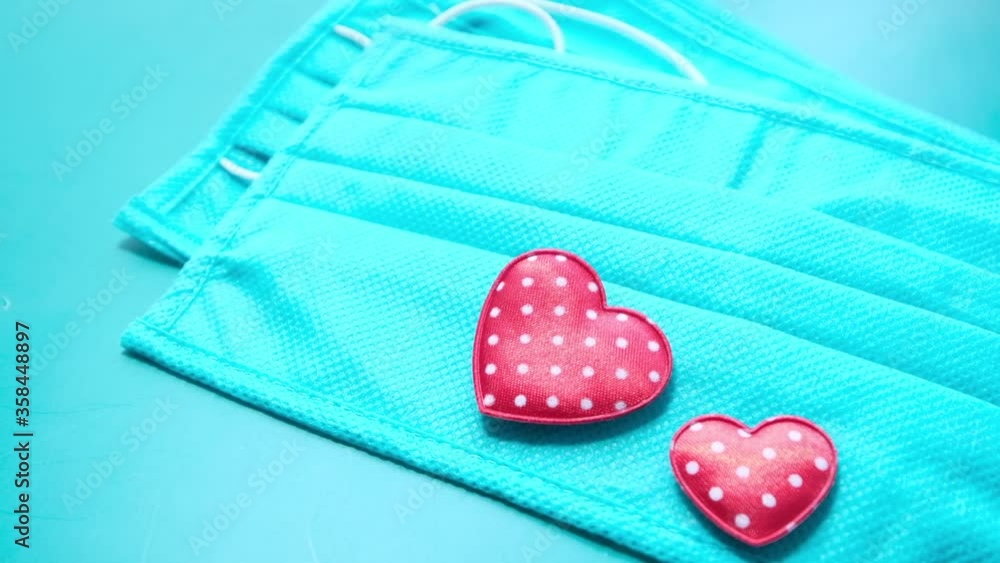 Surgical masks with heart shape on green background Surgical masks with heart shape on green background