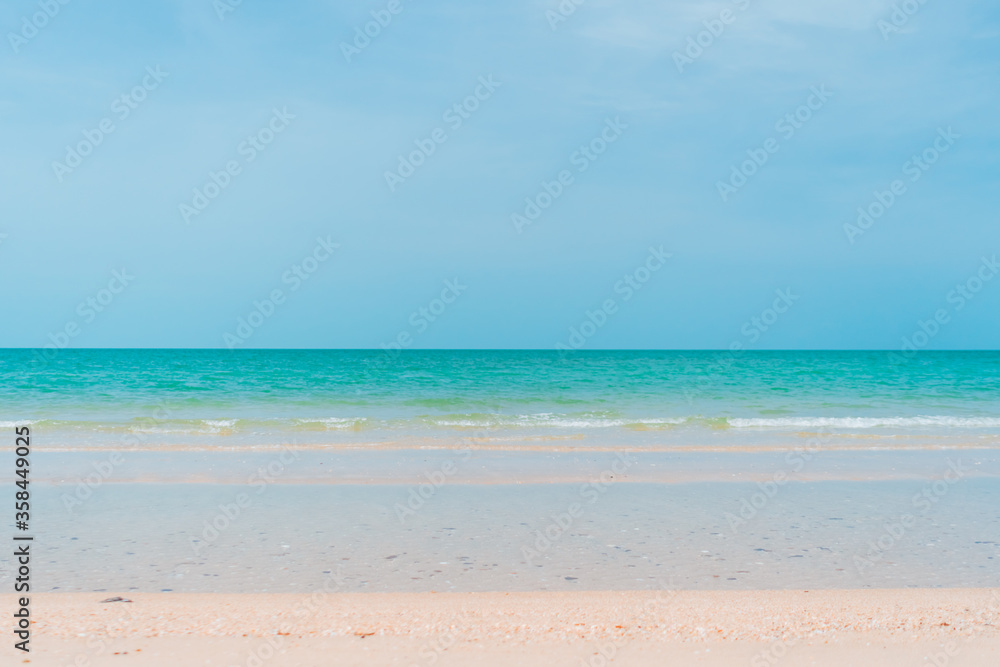 Tropical nature clean beach and white sand in summer with sun light blue sky and bokeh background.