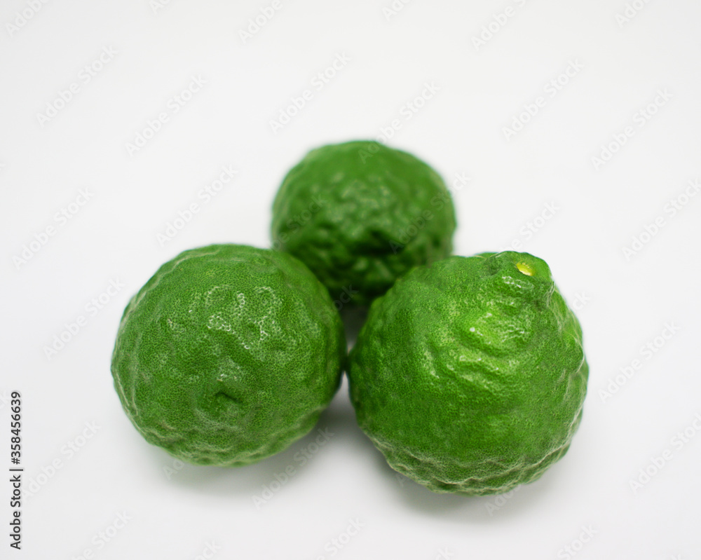 Fototapeta premium Bergamot, green fruit arranged on a white background