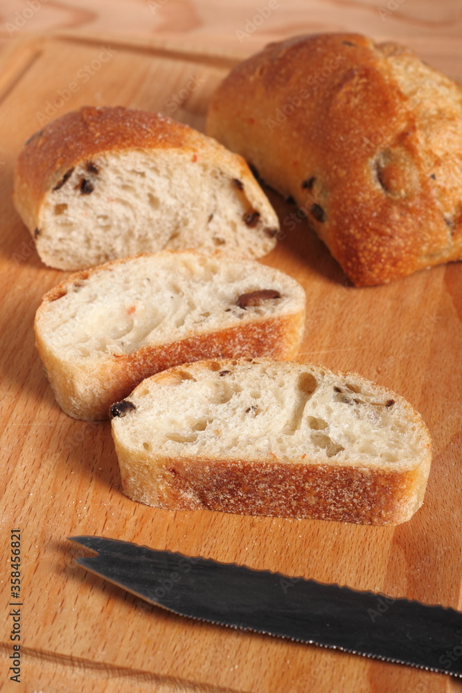 Ciabatta with black olives. Italian white bread.