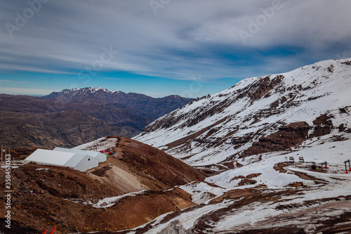 Winter landscape in Snowy Valley resort near Santiago de Chile, Chile. Thawing mountains in late august winter.
