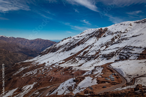 Winter landscape in Snowy Valley resort near Santiago de Chile, Chile. Thawing mountains in late august winter.