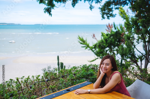 A beautiful young asian woman with the sea and blue sky view