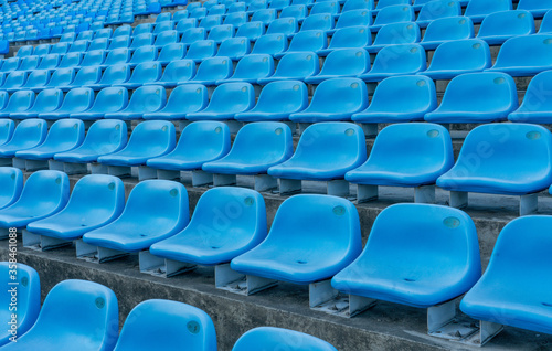blue empty stadium seats creating a pattern.