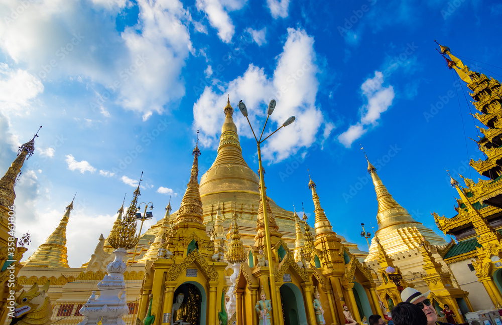 Naklejka premium Buddhist Pilgrims in the Shwedagon Pagoda at night. It is the most sacred Buddhist pagoda for the Burmese. decoration image contain​ certain​ grain​ noise and​ soft​ focus.