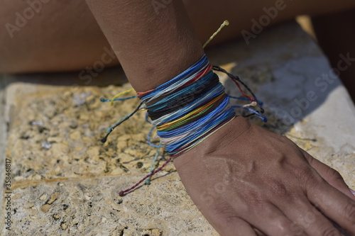 woman with armbands touching the edge of the pool with her fingers