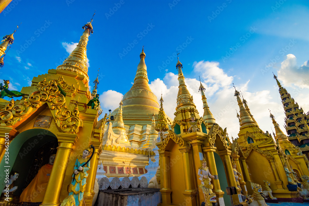 Naklejka premium Buddhist Pilgrims in the Shwedagon Pagoda at night. It is the most sacred Buddhist pagoda for the Burmese. decoration image contain​ certain​ grain​ noise and​ soft​ focus.