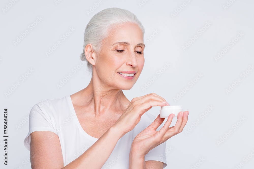 Close up photo of lovely lady with top-knot holding jar with nourishment wearing white trendy stylish t-shirt isolated over white background Close up photo of lovely lady with top-knot holding jar with nourishment wearing white trendy stylish t-shirt isolated over white background