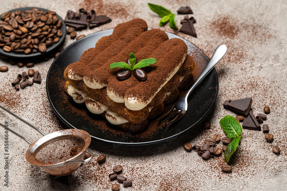 Classic tiramisu dessert on ceramic plate on concrete background Classic tiramisu dessert on ceramic plate on concrete background
