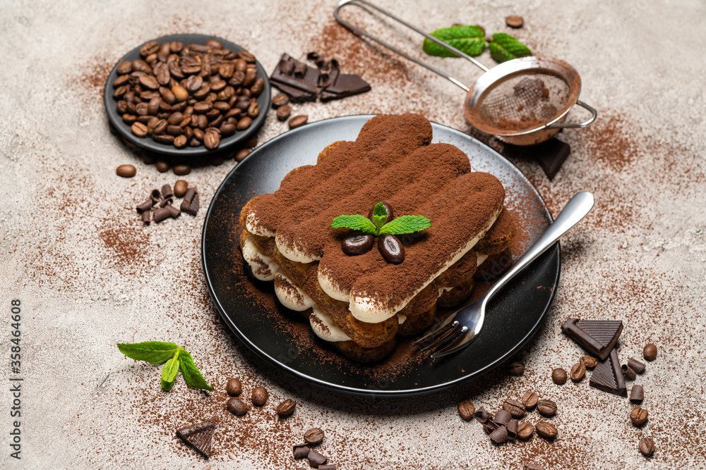 Classic tiramisu dessert on ceramic plate on concrete background Classic tiramisu dessert on ceramic plate on concrete background