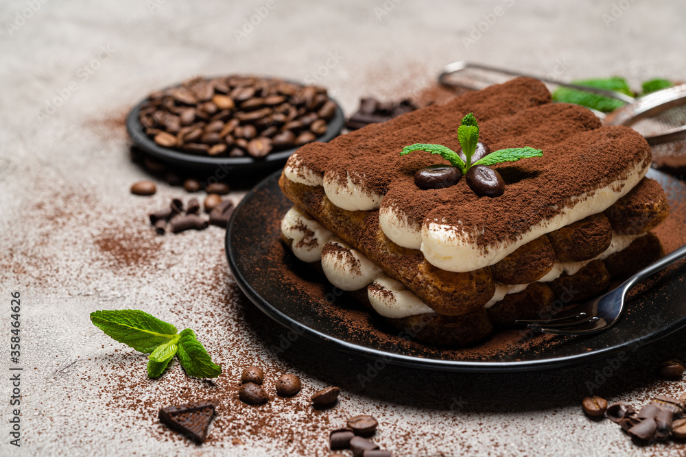 Classic tiramisu dessert on ceramic plate on concrete background Classic tiramisu dessert on ceramic plate on concrete background