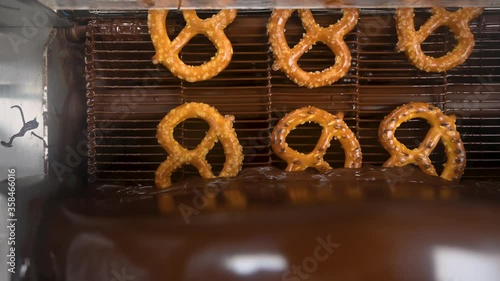 beautiful  Top view footage of  pretzels going through a chocolate enrober 
Can be used for many projects and background! photo