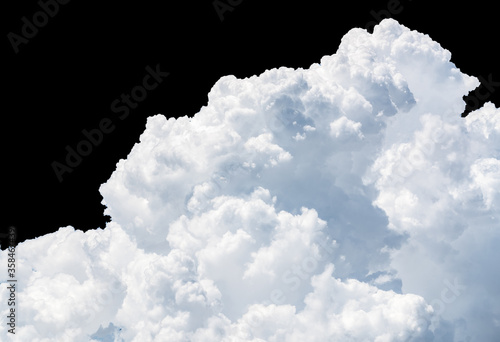 Pure white cumulus clouds on black background. Cloudscape background. White fluffy clouds on dark background. Soft cotton feel of white clouds texture isolated on black background. Soft touch clouds.