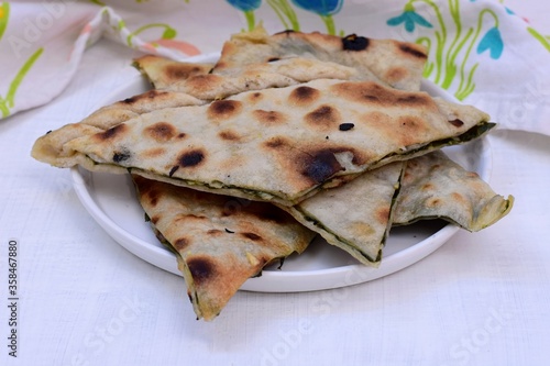 Slices of baked pied stuffed whit beet leafs and garlic/ Traditional Dalmatian cuisine/ Mediterranean food- Soparnik- Uljenak
