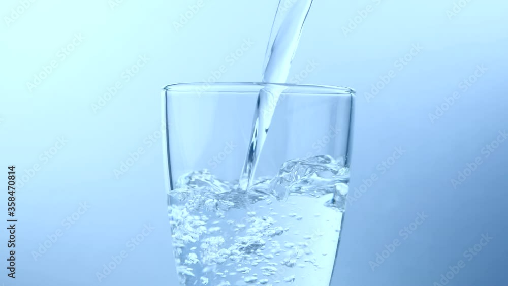 Water pouring into glass, slow motion Water pouring into glass, slow motion