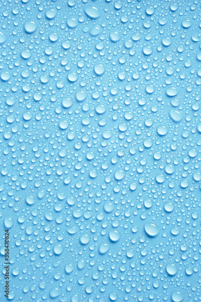 Beautiful big drinking water droplets on the light blue background. 