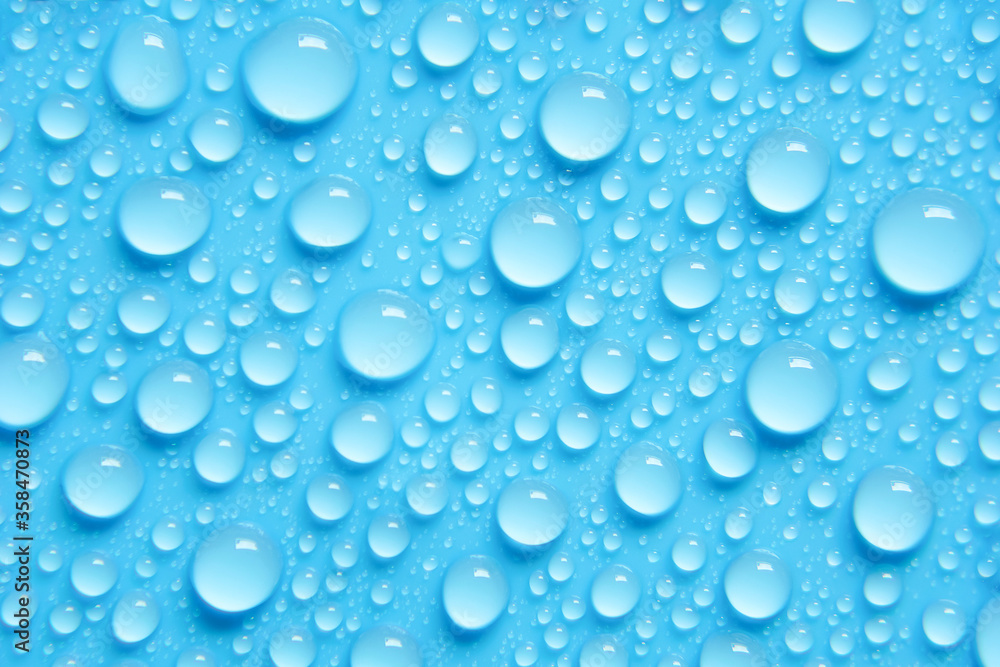 Beautiful big drinking water droplets on the light blue background. 