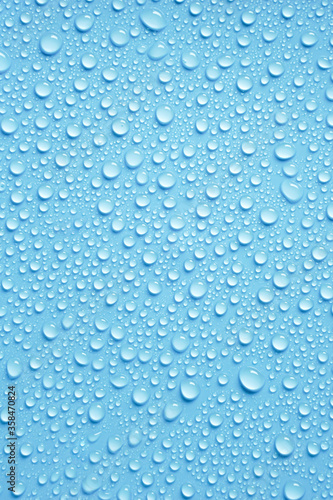 Beautiful big drinking water droplets on the light blue background. 