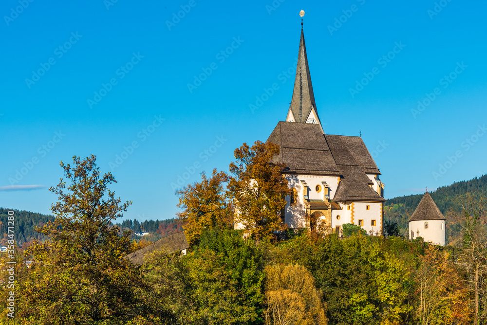Magical Gothic architecture in Austria. Panorama on Lake Worthersee. Maria Worth church and sanctuary.