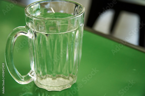 Glass of water on the green table