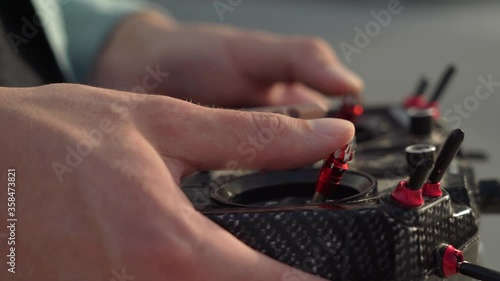 male hands control a remote controller on the street. close-up. fpv drone control photo