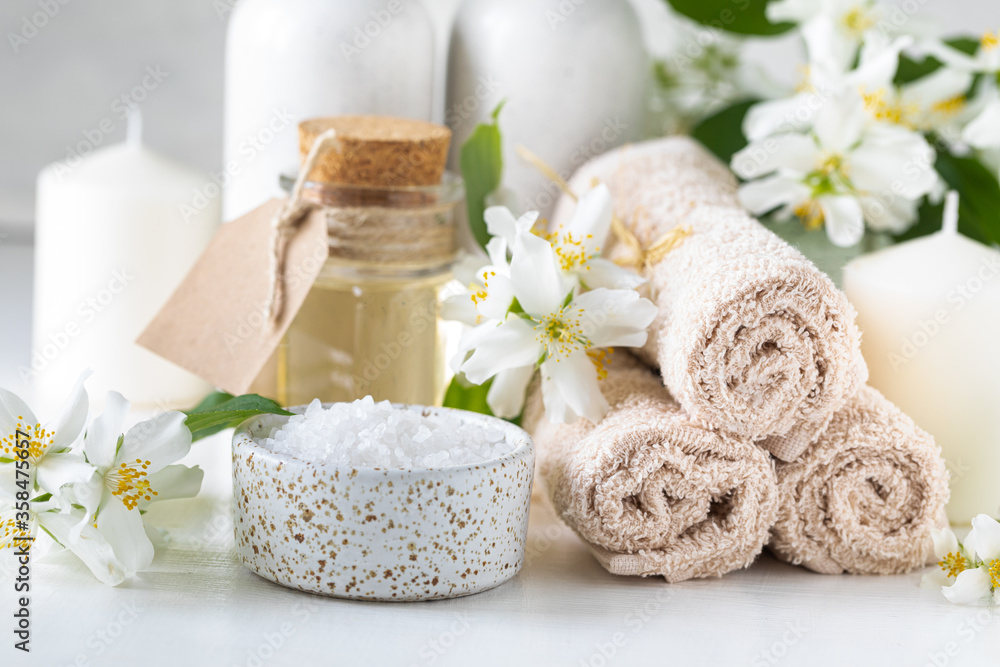 Spa composition with jasmine flowers on a white table close-up. Spa composition with jasmine flowers on a white table close-up.