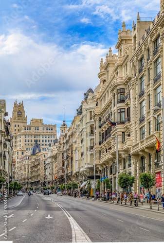 Beautiful buildings on the famous Gran Via shopping street and people walking in the center of the city in Madrid, Spain © SvetlanaSF