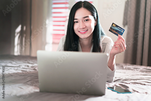 Woman show credit card and smile for business online concept