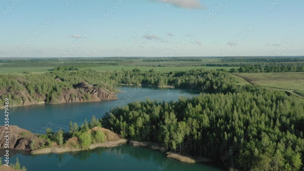 Romantsevo hills and lakes in Tula oblast drone aerial shot drone aerial pan shot left to right. Fly over tulskaya oblast romantsevskie hills, konduki shot under cloudy blue sky Romantsevo hills and lakes in Tula oblast drone aerial shot drone aerial pan shot left to right. Fly over tulskaya oblast romantsevskie hills, konduki shot under cloudy blue sky