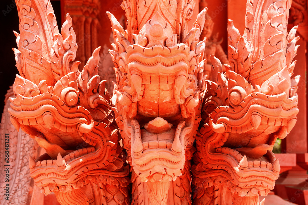 Close view of red dragon with 3 heads sculpture in Ko Samui, Thailand Close view of red dragon with 3 heads sculpture in Ko Samui, Thailand