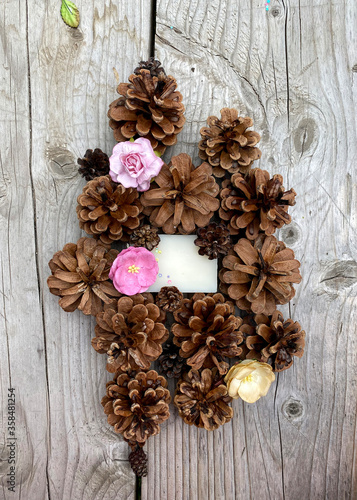 stylish wooden background with pine cones, copy space for text. seasonal holidays and SPA concept