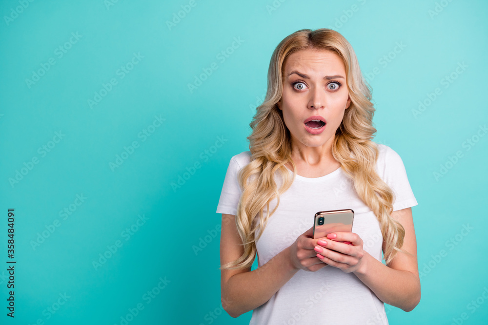 Portrait of frustrated anxious nervous girl use smart phone read social network notification corona virus information impressed wear good look clothes isolated over teal color background Portrait of frustrated anxious nervous girl use smart phone read social network notification corona virus information impressed wear good look clothes isolated over teal color background